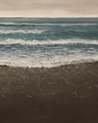 Waves crashing onto a beach with a cloudy sky above.